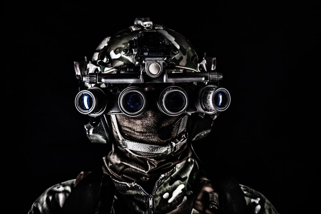 man wearing a helmet and goggles in the dark, highlighting the importance of rare earth elements in defense technology